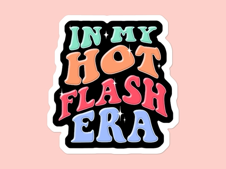 May include: A sticker with the text "IN MY HOT FLASH ERA" in a retro font. The words are in shades of blue, orange, pink, and green, outlined in black with white borders. The background is a light pink.