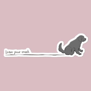 May include: A sticker featuring a gray dog sitting and leaving a mark on a pink background. The text "Leave your mark" is written in black on a white rectangle.