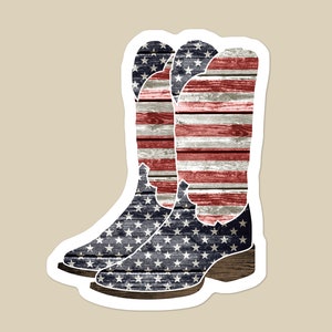 K&ouml;nnte beinhalten: Ein Paar Cowboystiefel mit amerikanischer Flaggen-Optik. Die Stiefel sind aus einem verwitterten Holz-&auml;hnlichen Material mit roten, wei&szlig;en und blauen Streifen und Sternen gefertigt.