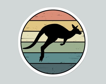 May include: A retro-style illustration of a kangaroo jumping in front of a sunset with a woodgrain texture.