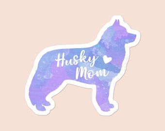 May include: A watercolor silhouette of a husky dog in shades of purple and blue with the text "Husky Mom" and a small white heart.