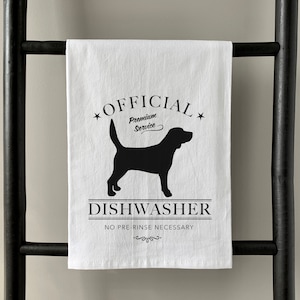 May include: White kitchen towel with a black silhouette of a dog and the text "OFFICIAL Premium Service DISHWASHER NO PRE-RINSE NECESSARY".