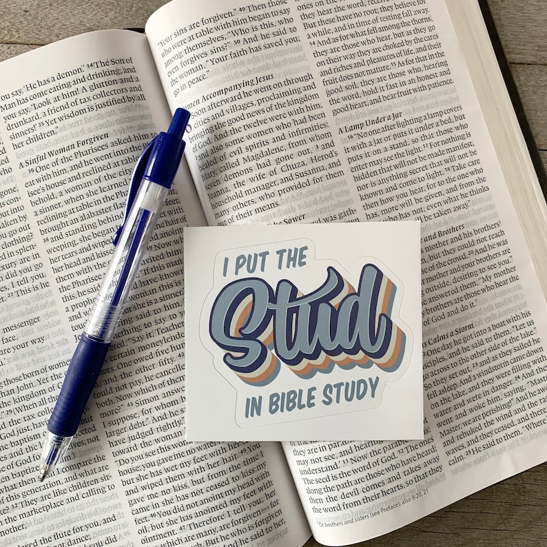 May include: A sticker with a blue, white, and orange design that says "I Put the Stud in Bible Study".