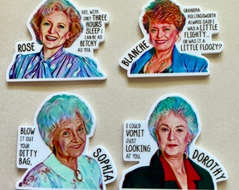 May include: Set of four die-cut stickers featuring portraits of characters from the Golden Girls. Each sticker has a different character name and quote: Rose, Blanche, Sophia, and Dorothy. The stickers are white with colorful illustrations.