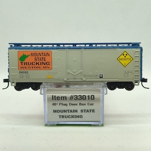 Custom painted and decaled N-scale Atlas boxcar, grey and blue with Mountain State Trucking logo