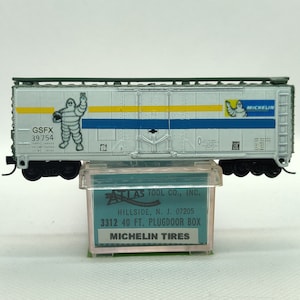 Custom painted and decaled N-scale Atlas boxcar, white & forest-green with Michelin Tires logo