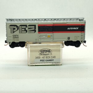 Custom painted and decaled N-scale Atlas boxcar, grey and silver with PEZ Candy logo