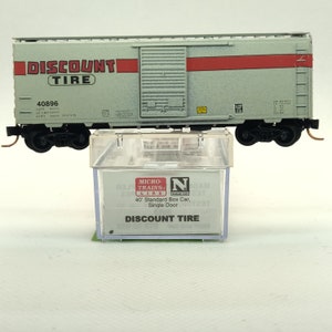 Custom painted and decaled N-scale Micro-Trains boxcar, white with Discount Tires logo