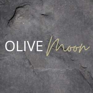 May include: A black and white image of the text "OLIVE Moon" on a dark gray textured background.
