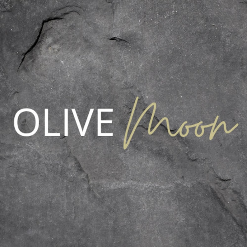May include: A black and white image of the text "OLIVE Moon" on a dark gray textured background.