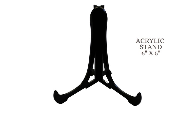 May include: Black acrylic display stand for artwork or photos. The stand is 6 inches by 5 inches.