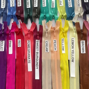 May include: A collection of 20 zipper pulls in various colors, including dark indigo, indigo blue, burgundy, emerald green, khaki, dark mint, mint, pistachio, ocean blue, beige, aubergine, violet, pink, red, pomegranate, sweet burgundy, cream, peach, yellow, lemon yellow, and brown.