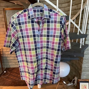 May include: A short-sleeved button-down shirt with a checkered pattern in shades of pink, blue, green, and yellow.