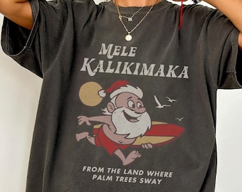 Camiseta navideña hawaiana vintage de los años 90, camiseta Mele Kalikimaka de colores cómodos, divertida camiseta de Papá Noel, camiseta de Papá Noel surfeando.