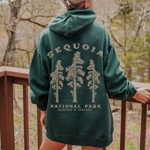 May include: A dark green hooded sweatshirt with the text "Sequoia National Park Respect & Explore" and a graphic of three trees.