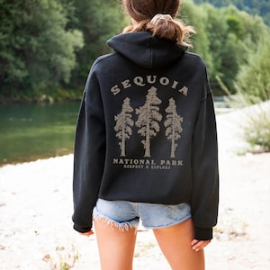 May include: Black hooded sweatshirt with a graphic print of three sequoia trees and the text "Sequoia National Park Respect & Explore".