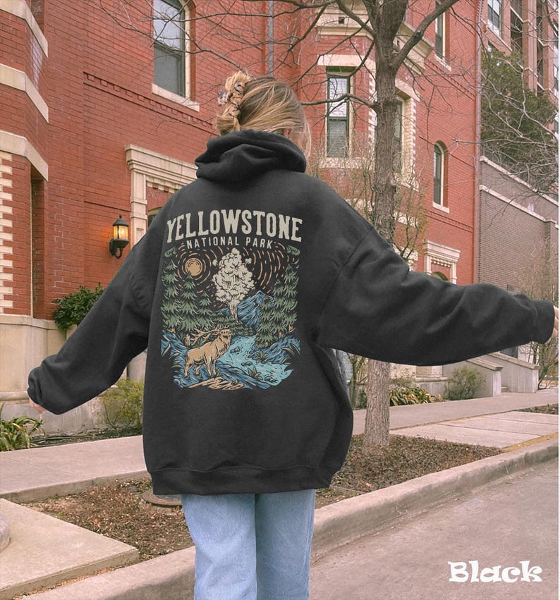 May include: Black hoodie with a graphic print of a forest scene and a deer. The text "Yellowstone National Park" is printed on the hoodie.