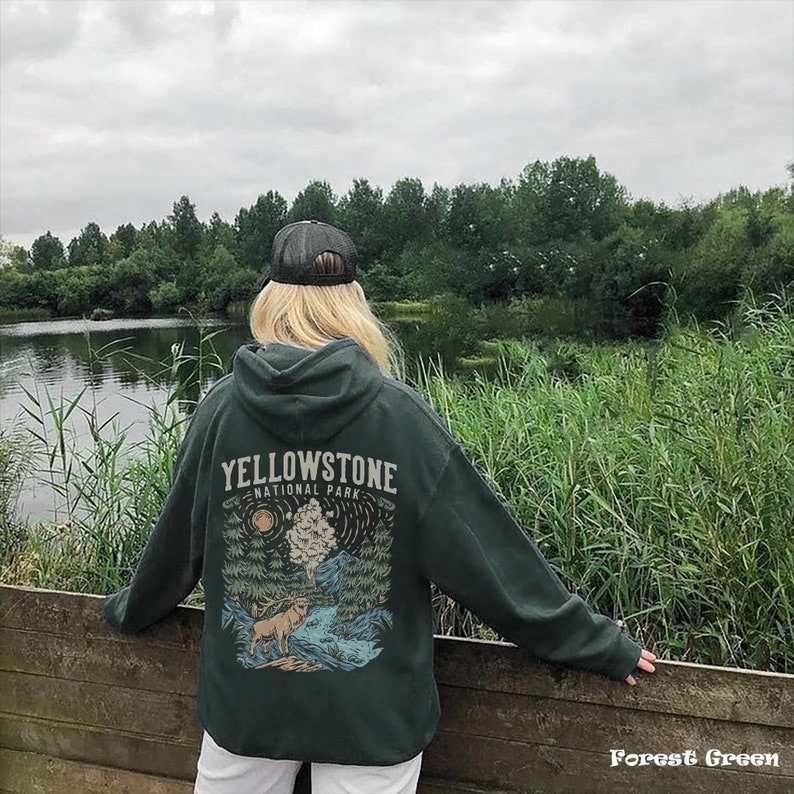 May include: A forest green hoodie with a graphic print of a mountain scene and the text "Yellowstone National Park".