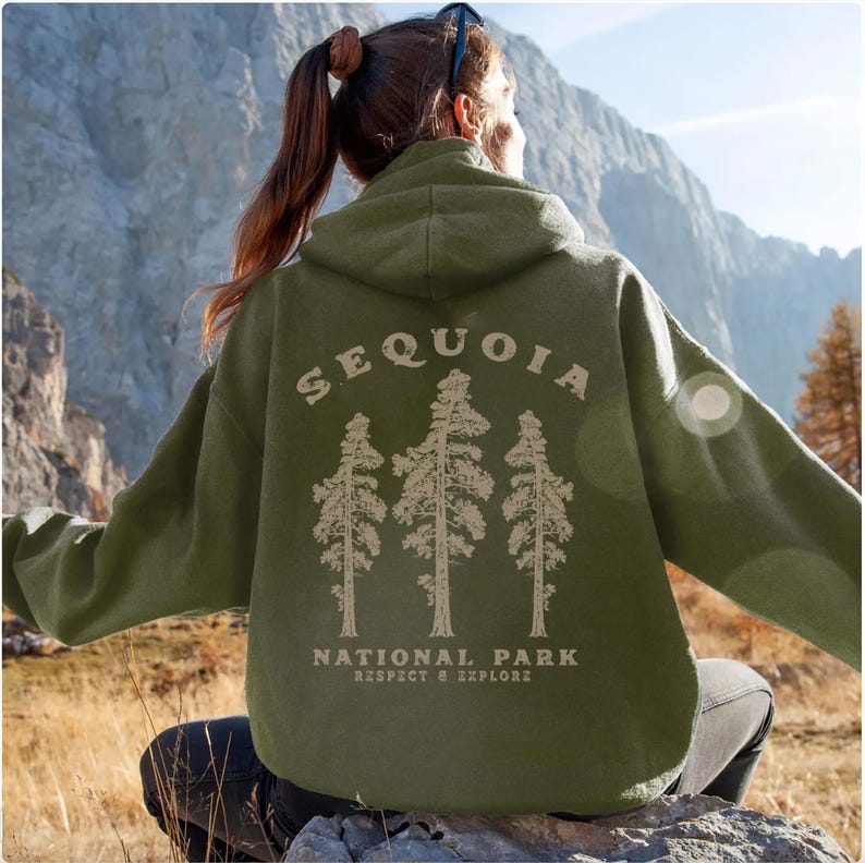 May include: Green hooded sweatshirt with a graphic of three sequoia trees and the text "Sequoia National Park Respect & Explore".
