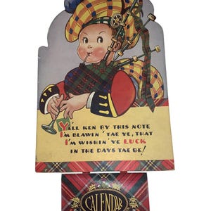 May include: A vintage-style wall calendar featuring an illustration of a child in a yellow and red tartan bonnet and outfit playing bagpipes. The text reads: Y'ELL KEN BY THIS NOTE I'M BLAWIN' TAE YE, THAT I'M WISHIN' YE LUCK IN THE DAYS TAE BE!