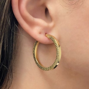 Stylish and stunning 14k yellow gold round hoops featuring a textured appearance and square tubular shape. These shiny ITALIAN gold hollow tubular earrings are lightweight and secure. Greek Key pattern Meandros trimmed square tubular hoop earrings.