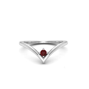 May include: A silver ring with a V-shaped band and a single red gemstone in the center.