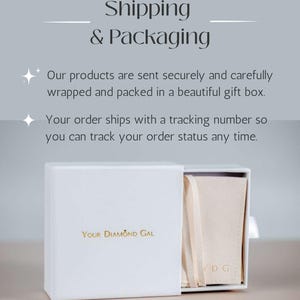May include: A white gift box with the text "Your Diamond Gal" in gold lettering. The box is partially open, revealing a beige pouch inside. The words "Shipping & Packaging" are at the top of the image.