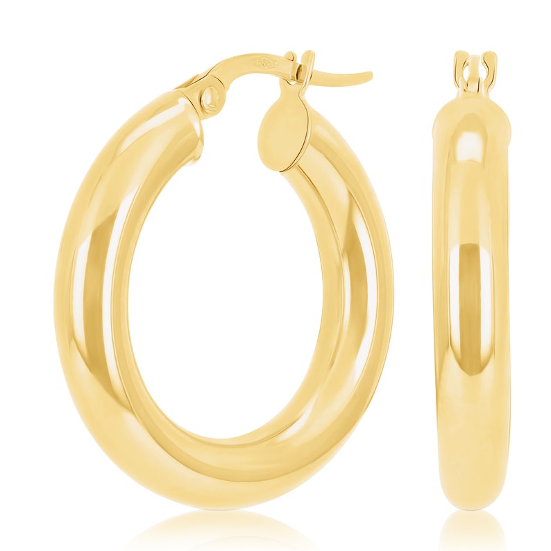 These 14k yellow gold round thick hoop earrings feature a rich, high polish shine, bringing out the tubular shape and smooth round finish. Click-top posts secure these trendy handcrafted yellow gold hoops, made for pierced ears. Lightweight hoops.