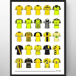 May include: A collection of 20 different Borussia Dortmund soccer jerseys, showcasing the team's uniform evolution from 1909 to present. The jerseys feature various sponsors, including Prestaith, Artic, s.Oliver, e-on, and Evonik. The jerseys are displayed in a grid pattern on a white background with a black frame and the text "EST. 1909" at the bottom.