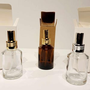 2 fl oz/60 mL. Set of 3, 6, or 12 Luxe AMBER or CLEAR Glass Spray Bottles. Gold or Silver Fine Mist Sprayer w/ Complimentary Product Box.