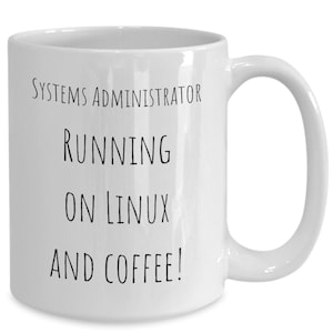 May include: White ceramic coffee mug with black text that reads "Systems Administrator Running on Linux and Coffee!"