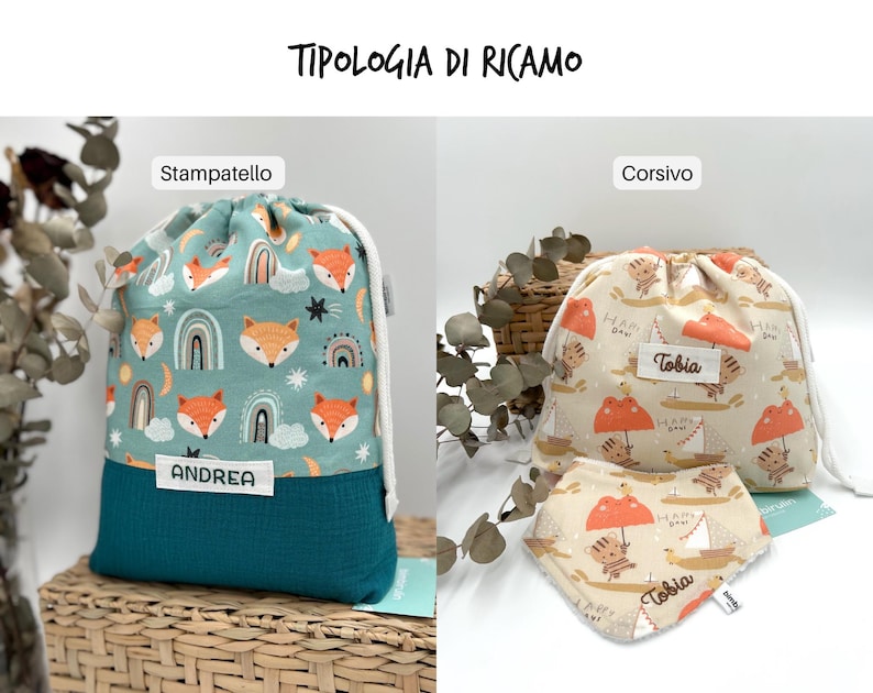 May include: Two drawstring bags and a bib. The left bag is teal with a fox and rainbow pattern and a white label reading ANDREA. The right bag and bib are beige with a tiger and sailboat pattern, featuring white labels with the name Tobia.
