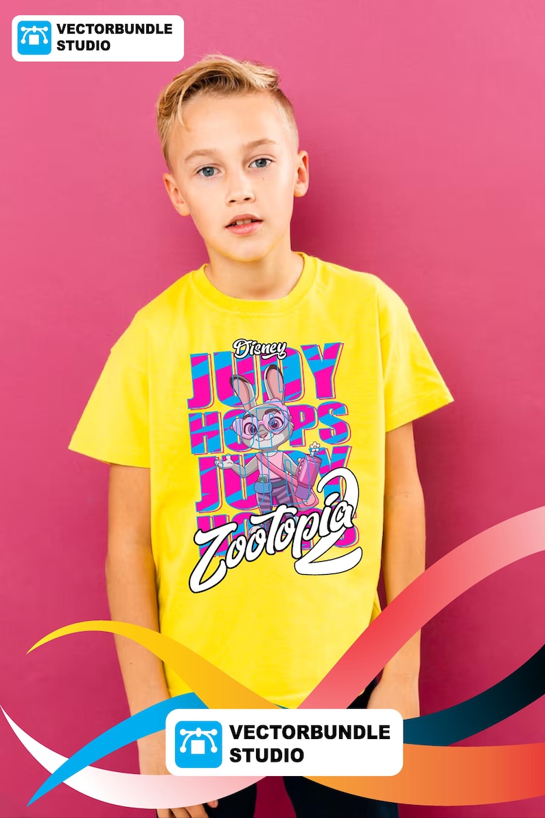 May include: A child wearing a yellow t-shirt with a colourful graphic of Judy Hopps from the Disney film Zootopia. The shirt displays the text "Judy Hopps" and "Zootopia 2". The background is a bright pink colour.