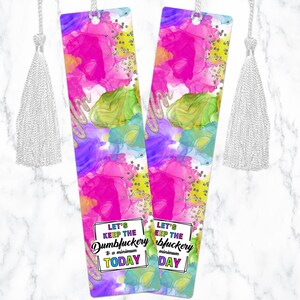 May include: Two colorful bookmarks with a white tassel. The bookmarks have a pink, green, blue, and purple abstract watercolor background with silver glitter. The text on the bookmarks reads "Let's keep the Dumbfuckery to a minimum today".