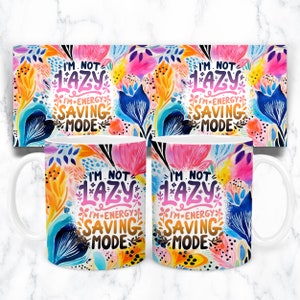 May include: White ceramic mug with a colorful floral design and the text "I'm not lazy I'm energy saving mode".