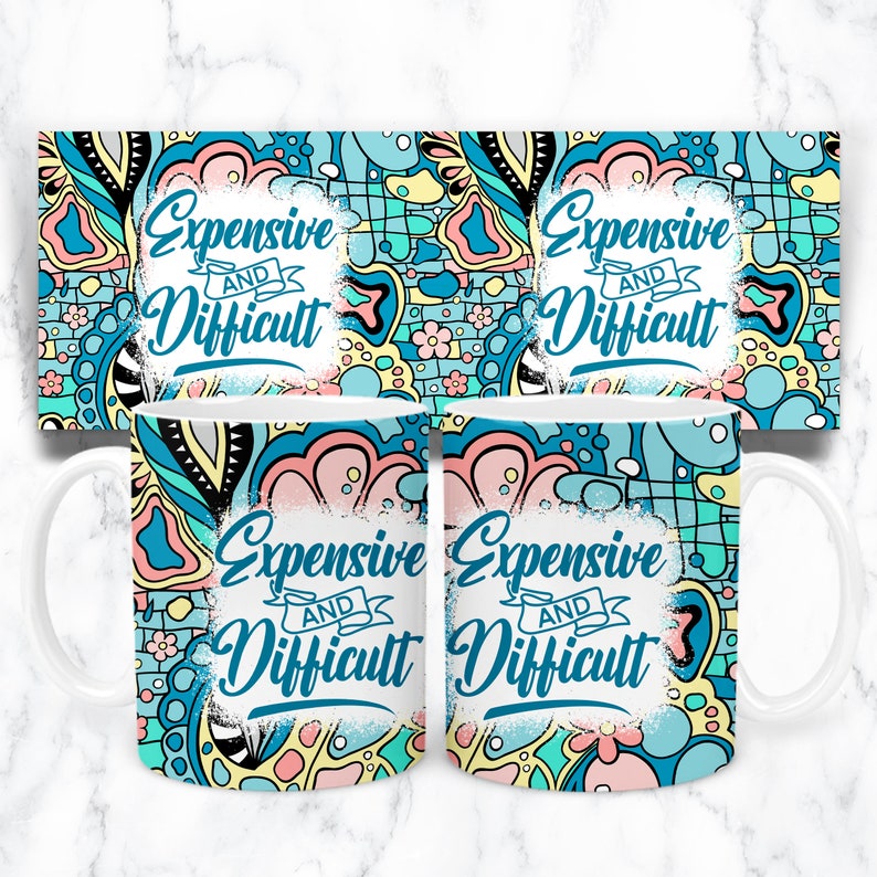 May include: Two white ceramic mugs with a blue, pink, and yellow abstract pattern. The mugs feature the text "Expensive and Difficult" in white.