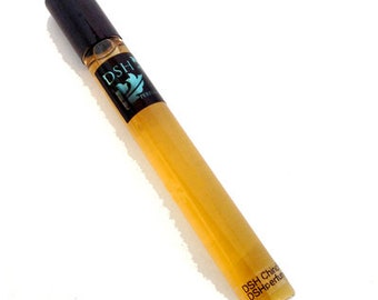 May include: A perfume bottle with a black cap and a clear glass body containing a golden liquid. The bottle has a black label with white text and a teal design. The base of the bottle has the text "DSH China DSHperfume".