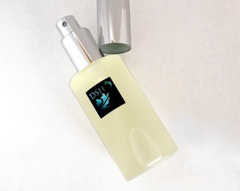 May include: A clear glass bottle with a silver spray nozzle and cap. The bottle is labeled with the text "DSH" and a green leaf design.