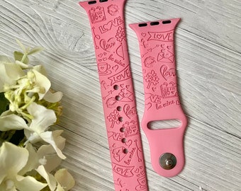 May include: Pink silicone watch band with a white and pink design featuring hearts, arrows, and the words "love", "be mine", and "22".