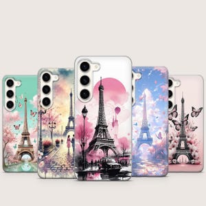 May include: Five phone cases with Eiffel Tower designs. Each case features a different color scheme, including pink, blue, and green, with illustrations of the Eiffel Tower, butterflies, and Parisian scenes. The cases have a glossy finish.