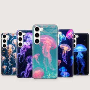 May include: A collection of phone cases featuring vibrant jellyfish designs. The cases showcase various colors, including pink, purple, blue, and orange, with detailed illustrations of jellyfish in an aquatic setting. The cases are designed to fit a smartphone.