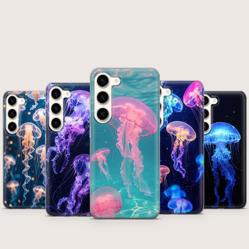 May include: A collection of phone cases featuring vibrant jellyfish designs. The cases showcase various colors, including pink, purple, blue, and orange, with detailed illustrations of jellyfish in an aquatic setting. The cases are designed to fit a smartphone.