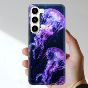 May include: A phone case featuring a vibrant design of purple jellyfish against a dark blue background. The case has a clear border and a camera cutout. The jellyfish have detailed tentacles and a glowing effect.
