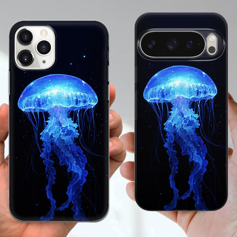 Puede incluir: Dos fundas negras para tel&eacute;fono con un dise&ntilde;o de medusa azul brillante sobre un fondo azul oscuro. La medusa tiene una apariencia detallada y luminosa con largos tent&aacute;culos fluidos. Las fundas se muestran desde el frente.