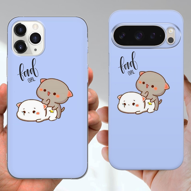 May include: Two light blue phone cases with a cartoon cat design. One case is for an iPhone, the other for a Google Pixel. The design features two cartoon cats, one gray and one white, with the text "bad girl".