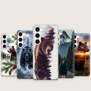 May include: A collection of phone cases featuring bear illustrations. The cases display various bear images, including a grizzly bear in a snowy scene, a black bear in a forest, and a bear with a sunset background. The cases are designed for a smartphone.