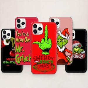 Op de afbeelding: Een verzameling telefoonhoesjes met Grinch-thema's. De hoesjes tonen de Grinch in verschillende poses, met teksten als "Merry Grinchmas" en "You're a Mean One, Mr. Grinch". Kleuren zijn rood, groen en zwart.