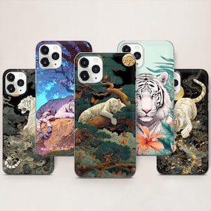May include: A collection of five phone cases featuring detailed illustrations of white tigers. Each case showcases a unique design, including tigers in various poses amidst natural settings with vibrant colors and intricate details.