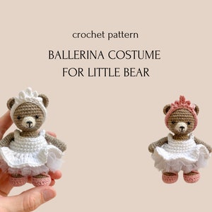 May include: Crochet pattern for a ballerina costume for a small teddy bear. The costume is white with a pink crown and pink shoes. The bear is brown with a white crown.