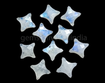 May include: A collection of ten iridescent moonstone star-shaped cabochons. The stones are a milky white with a blue sheen.
